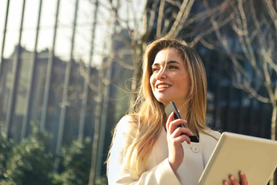 woman holding phone smiling