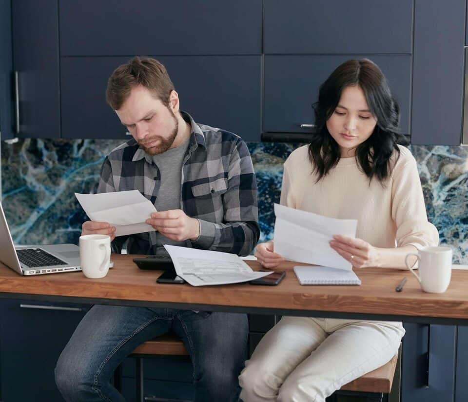 young couple reviewing finances at table