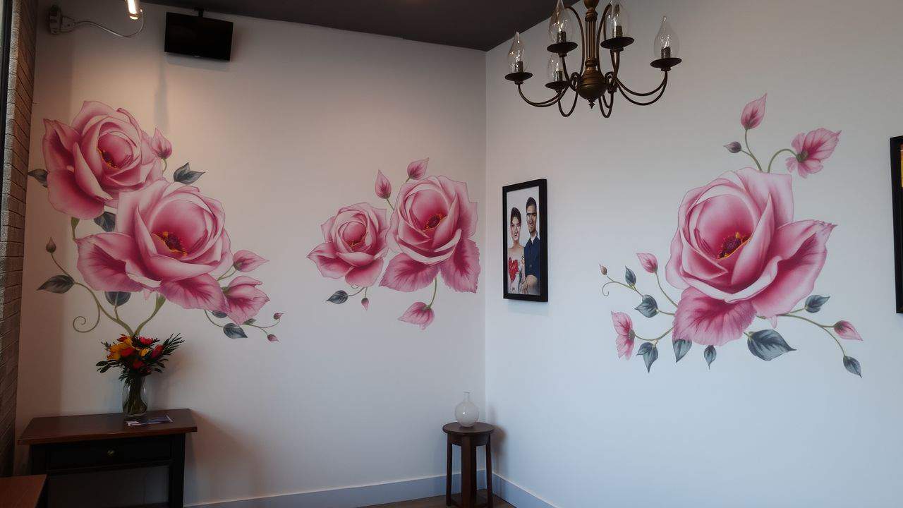 A stylish, inviting tattoo studio with feminine art designs and muted tones.